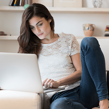 woman on couch using laptop