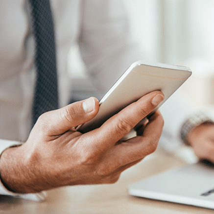 Manage Your Accounts on the Go hand holding mobile phone