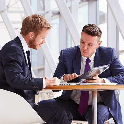 Features two men in looking at document