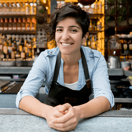 High Volume, High Balance Businesses Female cashier