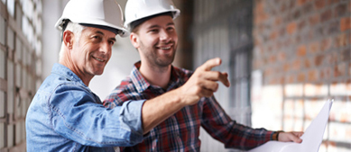 Finance Growth male contractors looking at blueprints