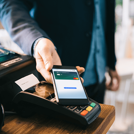 Benefits man paying cashier with mobile phone