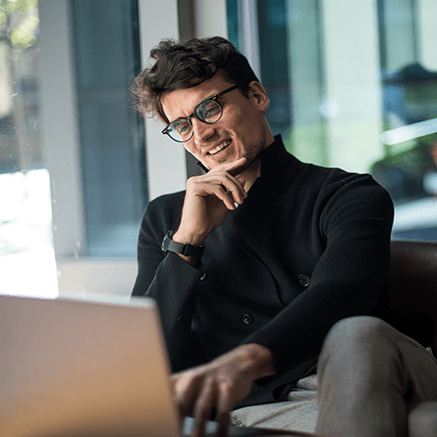 Improve Productivity, Increase Revenue man looking at laptop