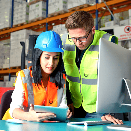 Manage Payables Efficiently construction workers looking at tablet