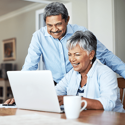 Rates & Requirements couple smiling looking at laptop