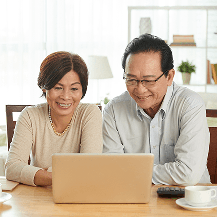 couple planning for retirement on laptop