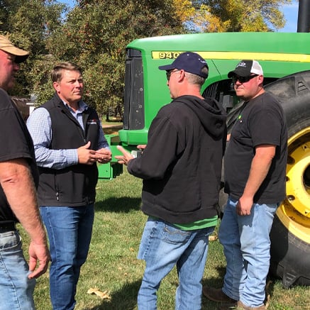 Protect Your Investment banker talking to two farmers