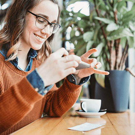 The Details woman depositing check with mobile phone