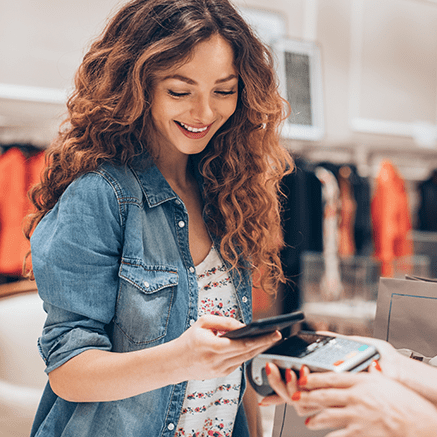 woman paying bill with mobile phone