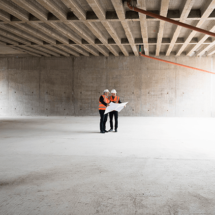 Building & Construction Loans two people on construction site looking at blueprints