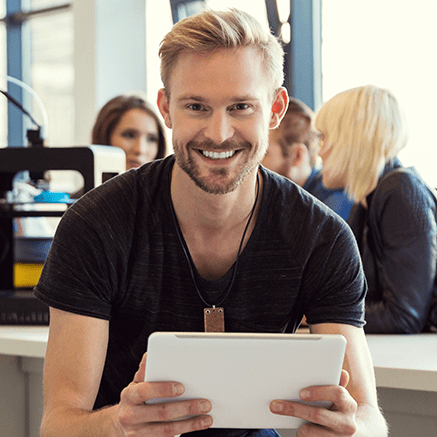 The Benefits man using tablet smiling