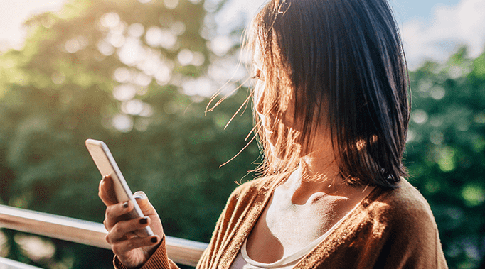 woman looking at mobile phone