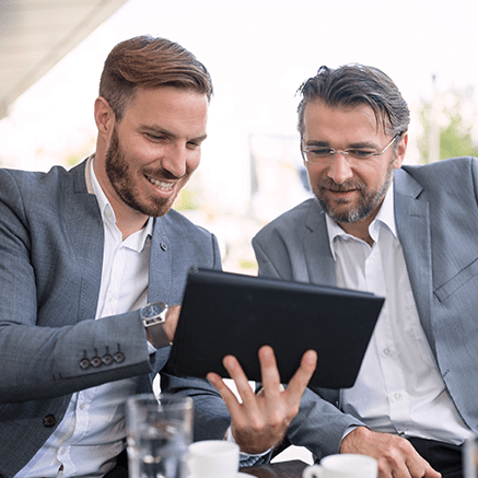 Electronic Data Interchange (EDI) two business men looking at tablet