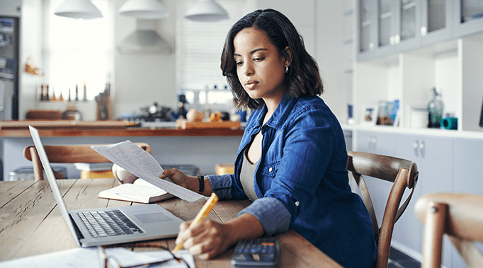 woman working with papers and laptop