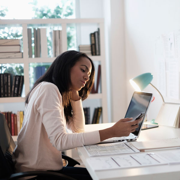 Woman sitting at desk working on laptop